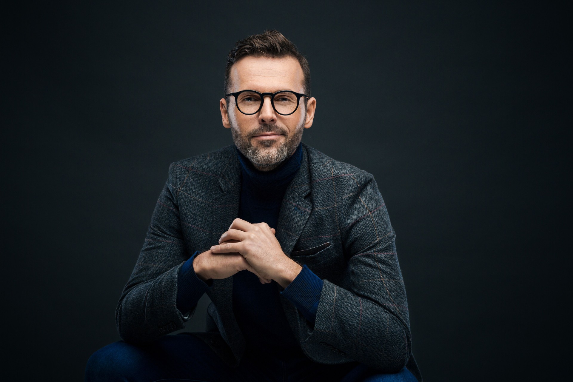 Studio portrait of elegant man, dark background